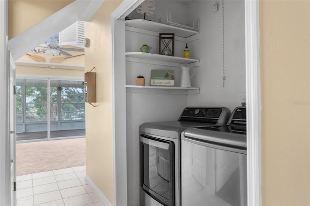 laundry room featuring light colored carpet, independent washer and dryer, laundry area, and light tile patterned flooring