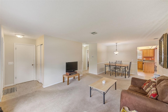 carpeted living room featuring a textured ceiling