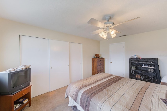 bedroom featuring ceiling fan and light carpet