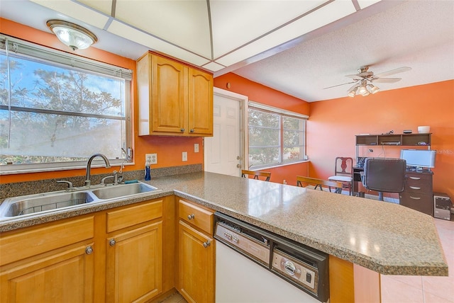 kitchen with dishwasher, ceiling fan, kitchen peninsula, and sink