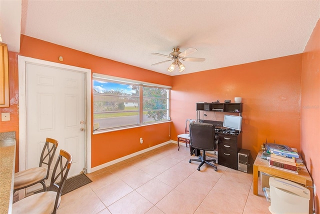 tiled office space with ceiling fan and a textured ceiling