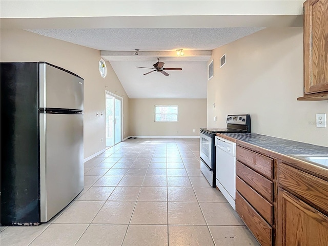 kitchen with ceiling fan, light tile patterned floors, a textured ceiling, and appliances with stainless steel finishes