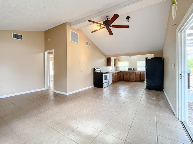 unfurnished living room with beam ceiling, ceiling fan, light tile patterned floors, and a textured ceiling