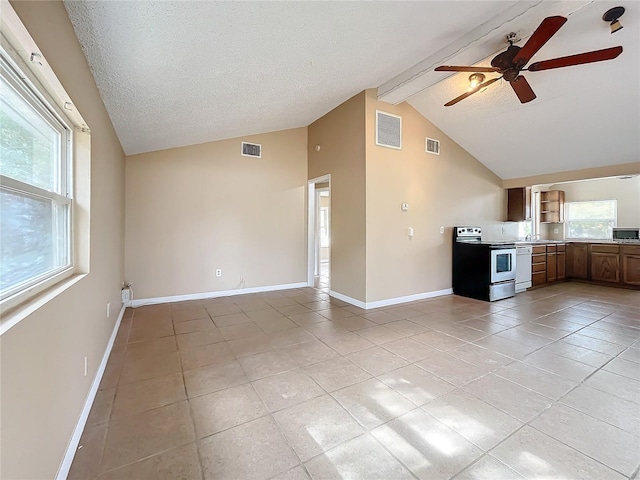 unfurnished living room with a textured ceiling, lofted ceiling with beams, light tile patterned floors, and ceiling fan