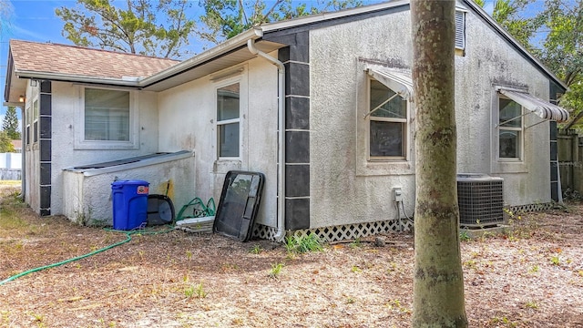 view of side of property with cooling unit