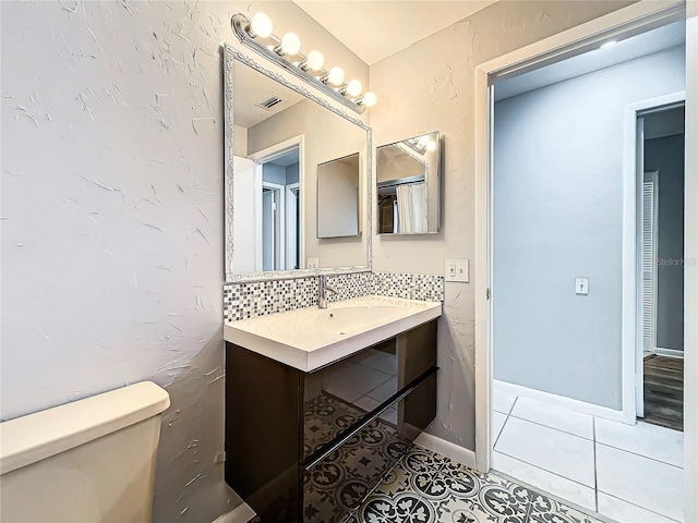 bathroom featuring sink, tile patterned flooring, and toilet