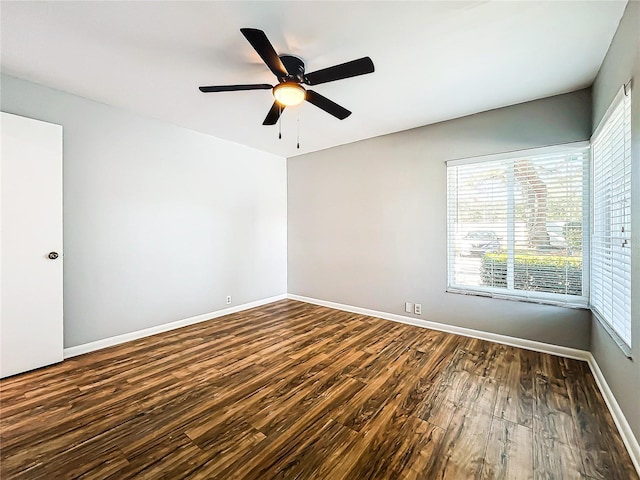 empty room featuring ceiling fan and dark hardwood / wood-style flooring