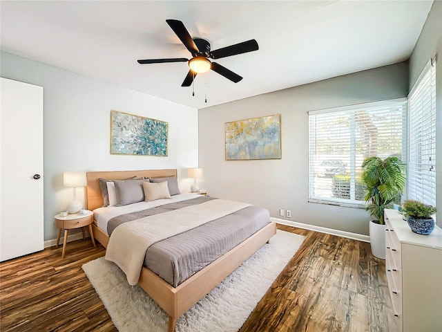 bedroom featuring dark hardwood / wood-style floors and ceiling fan