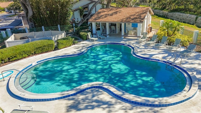 view of swimming pool with a patio area and an outdoor structure