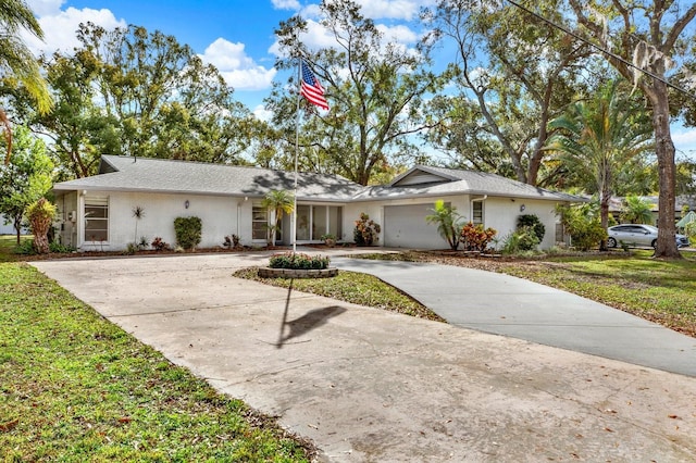 single story home featuring a front yard and a garage