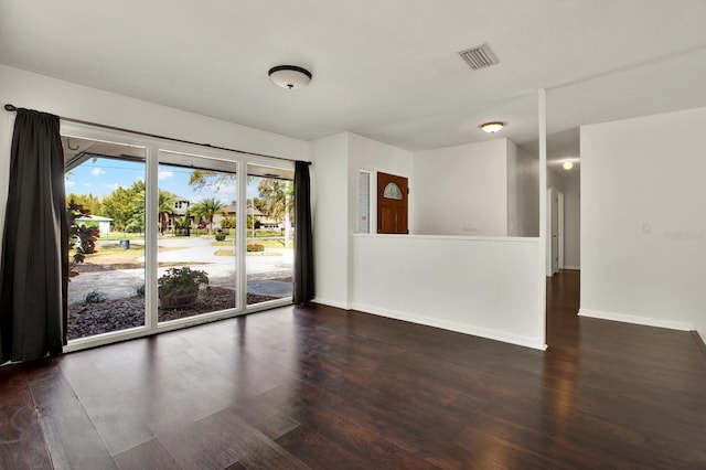 spare room featuring dark hardwood / wood-style flooring