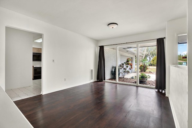 spare room featuring hardwood / wood-style flooring