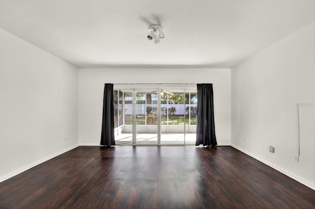 spare room featuring wood-type flooring