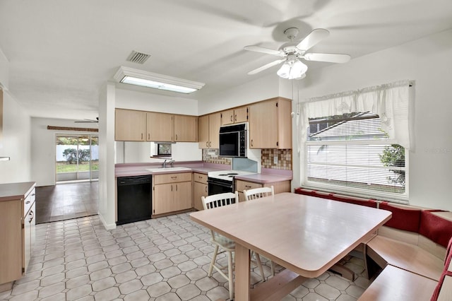 kitchen featuring decorative backsplash, light brown cabinetry, ceiling fan, sink, and black appliances