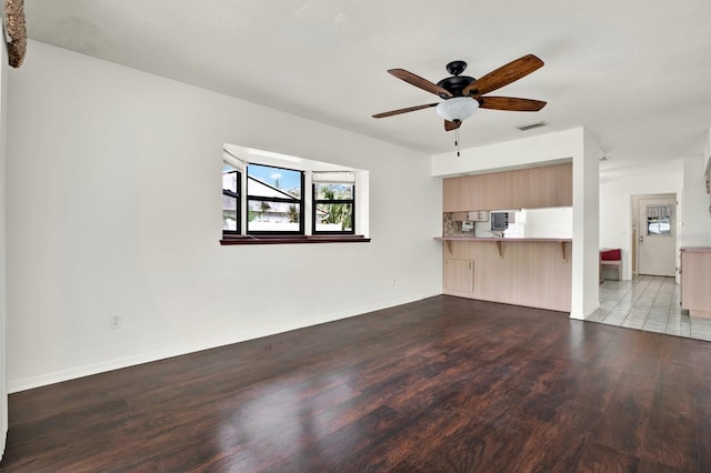 unfurnished living room featuring ceiling fan and light hardwood / wood-style flooring