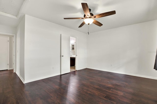 spare room with ceiling fan and dark hardwood / wood-style flooring