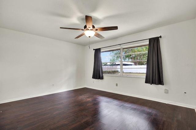 unfurnished room with ceiling fan and dark hardwood / wood-style floors