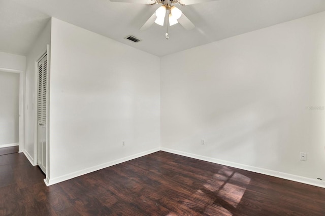 unfurnished room with ceiling fan and dark wood-type flooring