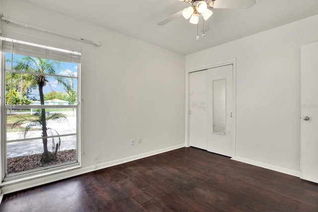 spare room featuring ceiling fan and dark hardwood / wood-style flooring