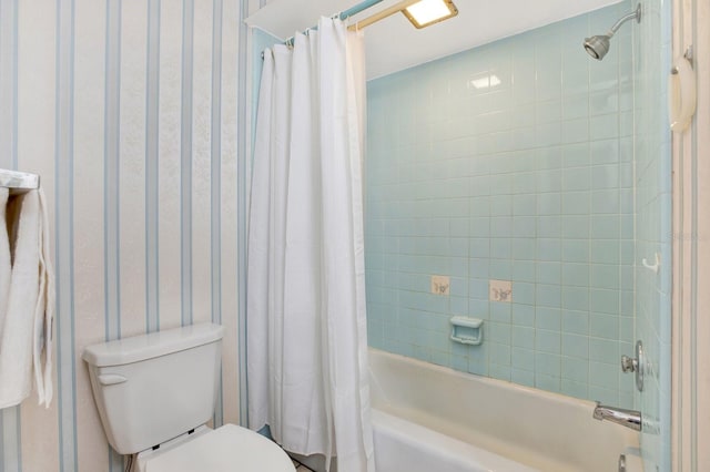 bathroom featuring shower / tub combo and toilet