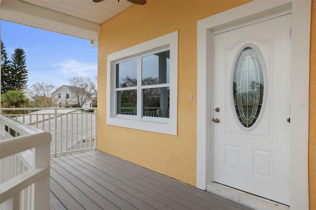 view of exterior entry with ceiling fan