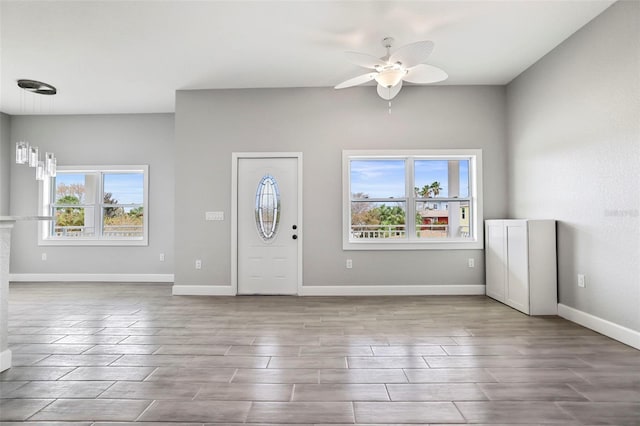 foyer with ceiling fan and plenty of natural light