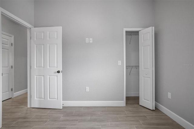 unfurnished bedroom featuring a closet and a walk in closet