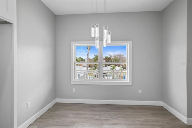 unfurnished dining area with an inviting chandelier