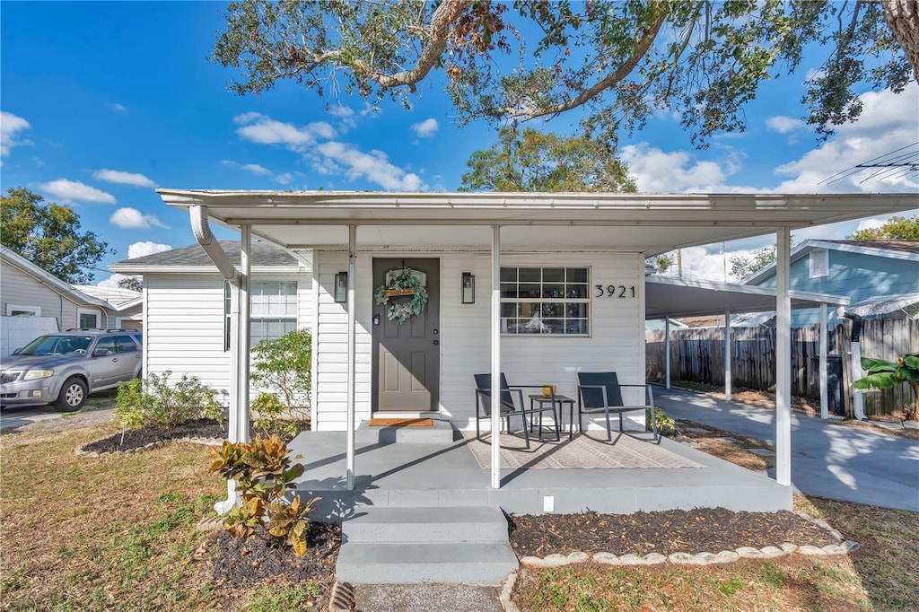 view of front of property featuring a porch and a carport