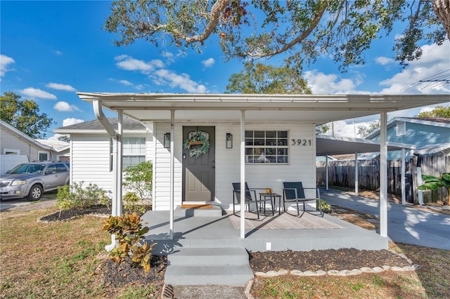 view of front of property featuring a porch and a carport