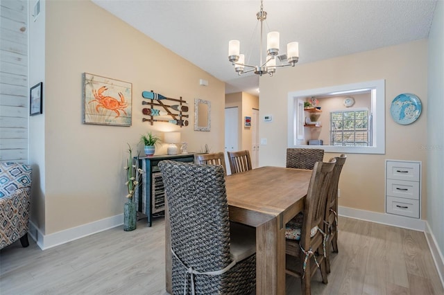 dining room featuring light hardwood / wood-style floors and a notable chandelier