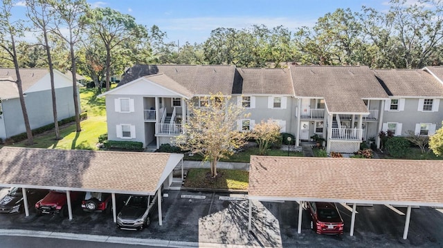 rear view of property with a carport