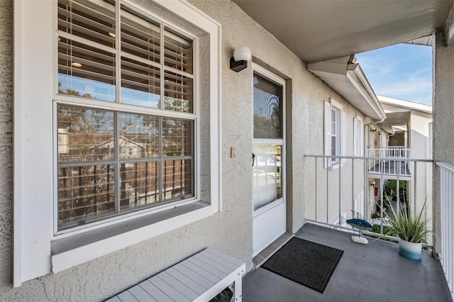 view of exterior entry featuring a balcony