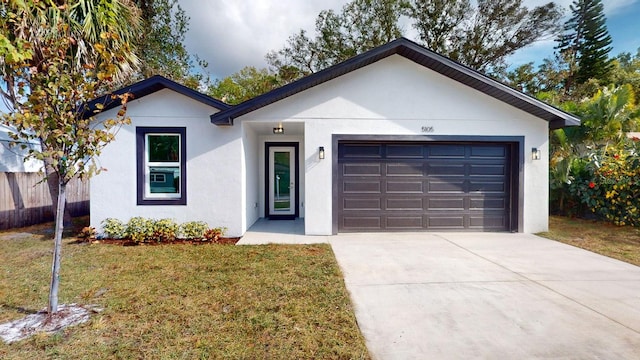 view of front of house with a garage and a front yard