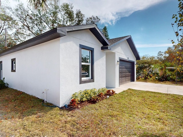 view of property exterior featuring a yard and a garage