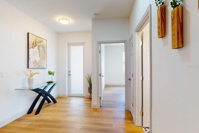 hallway with light hardwood / wood-style floors