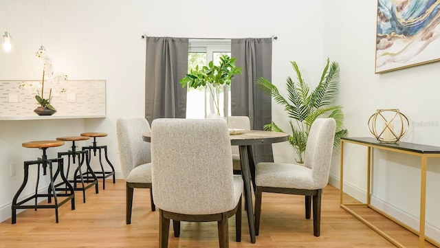 dining area featuring light wood-type flooring