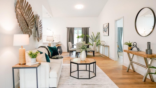 living room with light wood-type flooring and lofted ceiling