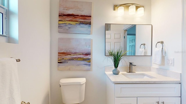 bathroom featuring vanity and toilet