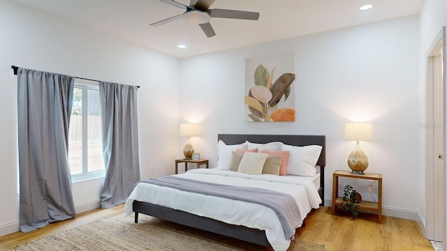 bedroom with ceiling fan and light wood-type flooring