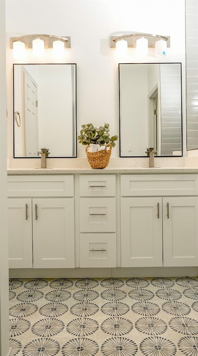 bathroom featuring tile patterned flooring and vanity