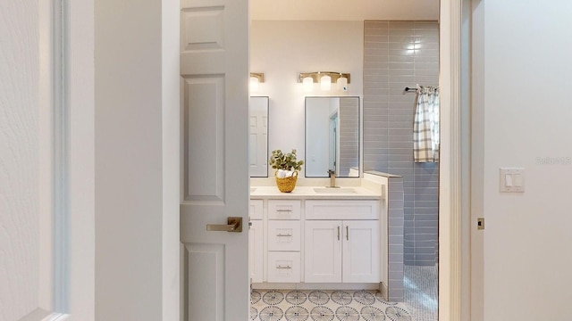 bathroom with vanity and a shower