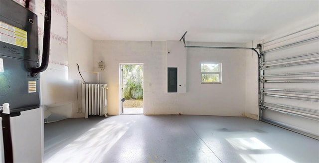 garage featuring electric panel and radiator