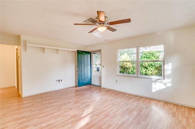 empty room with light wood-type flooring, ceiling fan, and beam ceiling