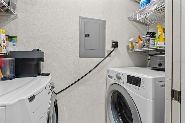 clothes washing area with separate washer and dryer and electric panel