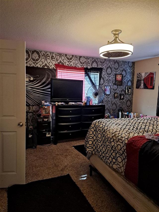 bedroom with a textured ceiling and carpet flooring