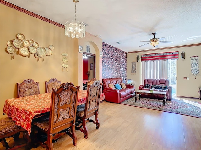 dining room featuring ceiling fan with notable chandelier, hardwood / wood-style flooring, and ornamental molding