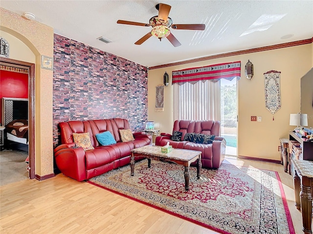 living room with ceiling fan, crown molding, and hardwood / wood-style flooring