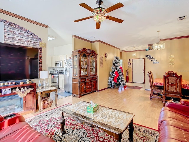 living room with ceiling fan with notable chandelier, light wood-type flooring, and crown molding