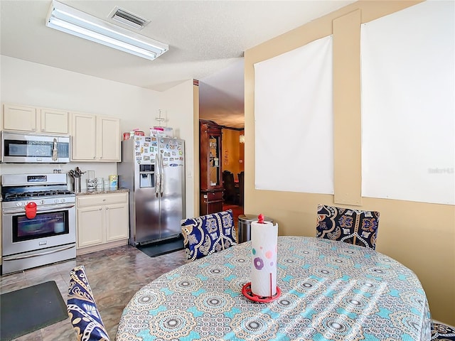 kitchen featuring white cabinets and appliances with stainless steel finishes